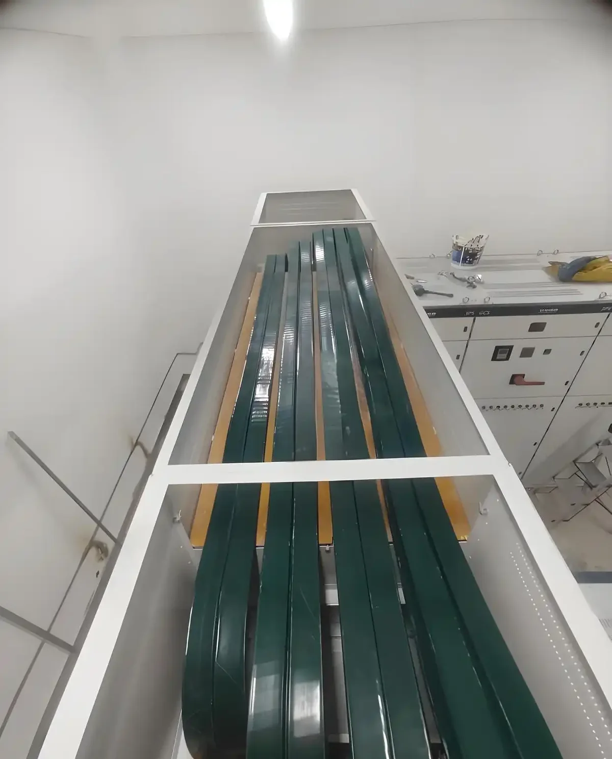 Cable run in a concrete channel between switchgear bays
