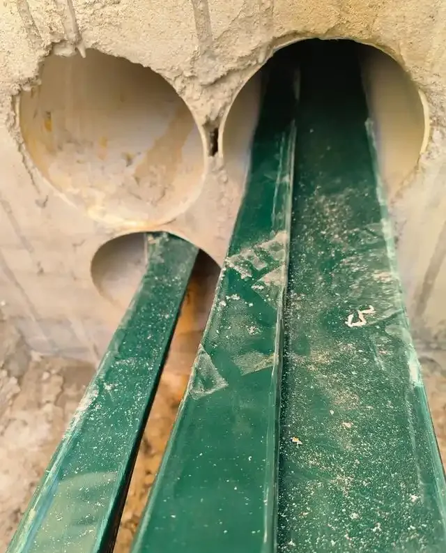 Cable sleeved through a concrete wall opening