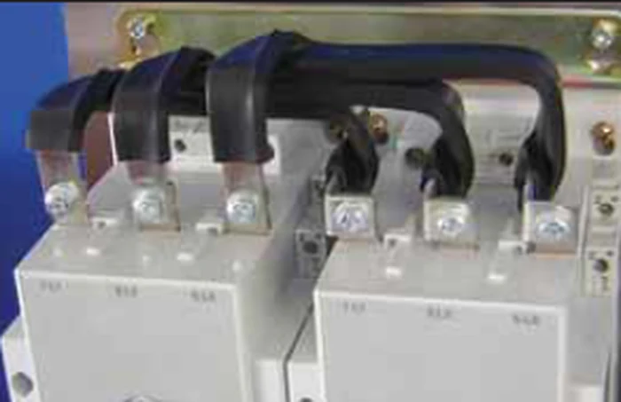 Insulated laminated busbars bolted onto contactors inside a cabinet